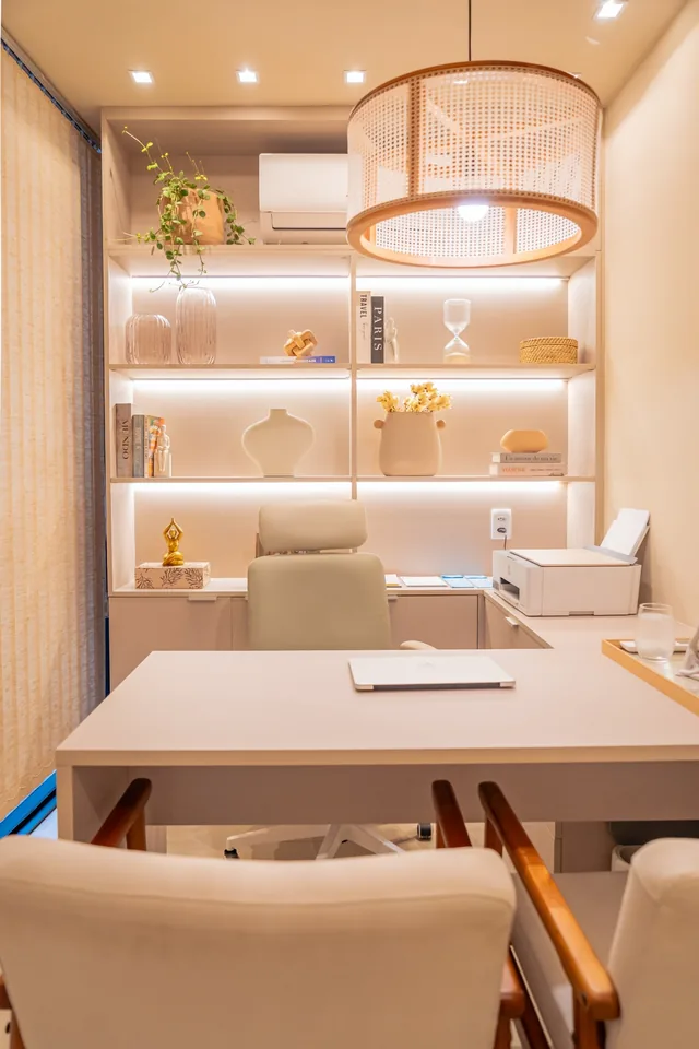 Custom home office with a lit shelving unit, a desk and wood shelves